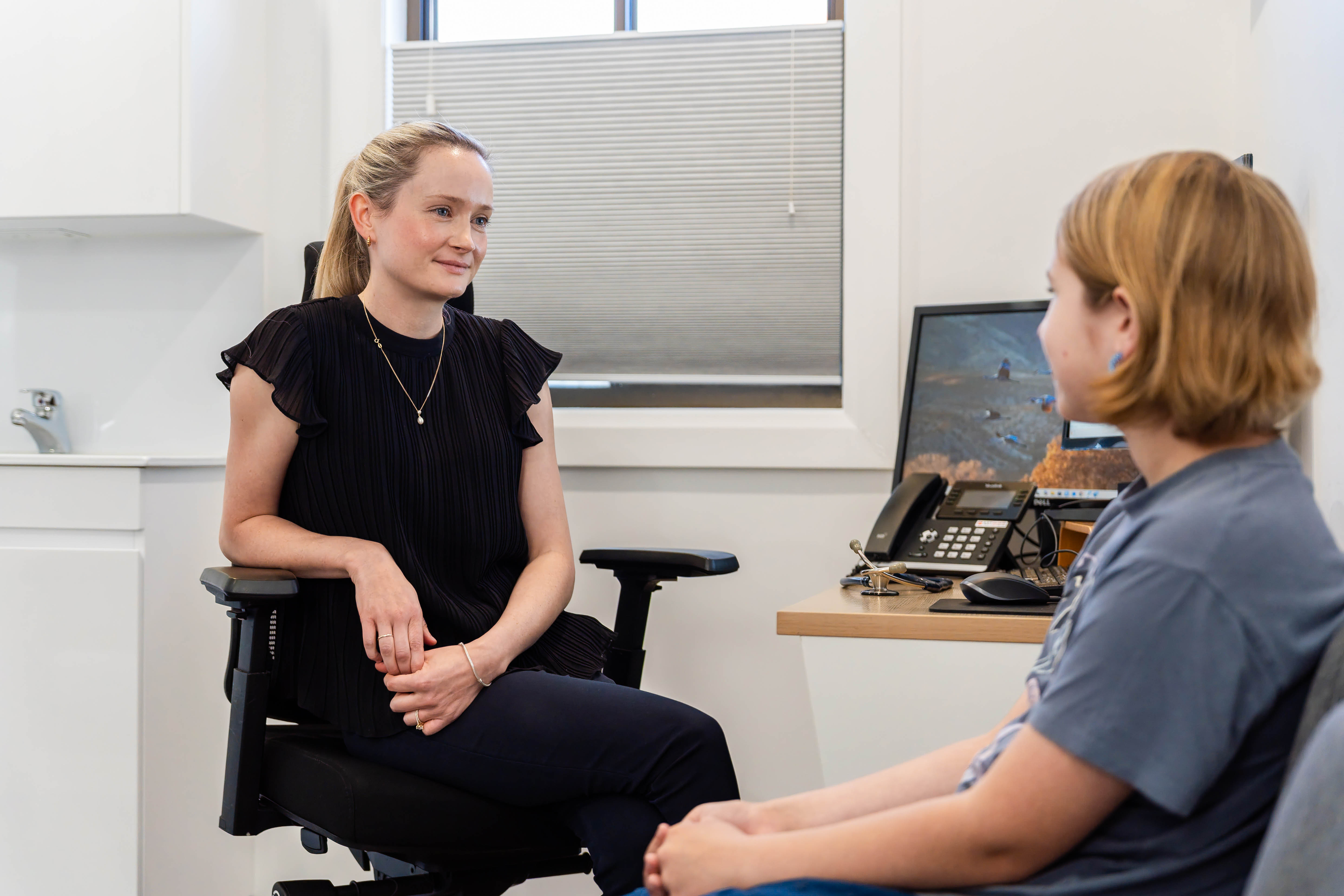 Dr Alexandra Sweeney consulting with a young patient